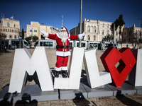 In Jerusalem, Israel, on December 19, 2024, Christian Palestinian Issa Kassissieh, dressed as Santa Claus, greets the public from the old ci...