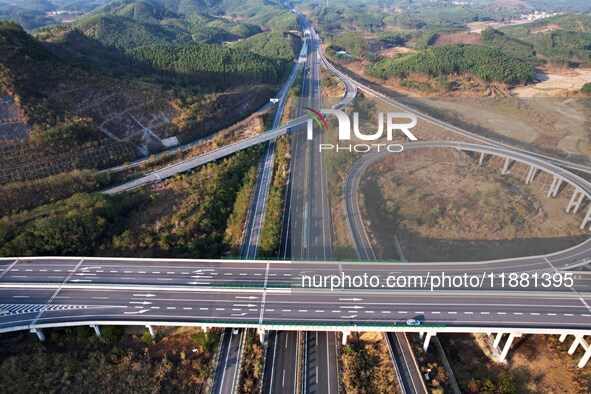 Vehicles drive on the Hongling interconnecting section of an expressway in Daliang town, Rongan County, Liuzhou city, South China's Guangxi...