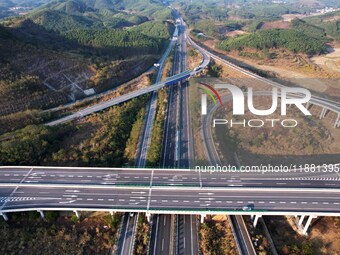 Vehicles drive on the Hongling interconnecting section of an expressway in Daliang town, Rongan County, Liuzhou city, South China's Guangxi...