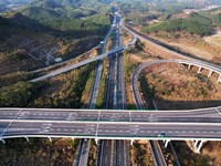 Vehicles drive on the Hongling interconnecting section of an expressway in Daliang town, Rongan County, Liuzhou city, South China's Guangxi...