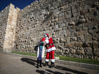 In Jerusalem, Israel, on December 19, 2024, Christian Palestinian Issa Kassissieh, dressed as Santa Claus, greets the public from the old ci...