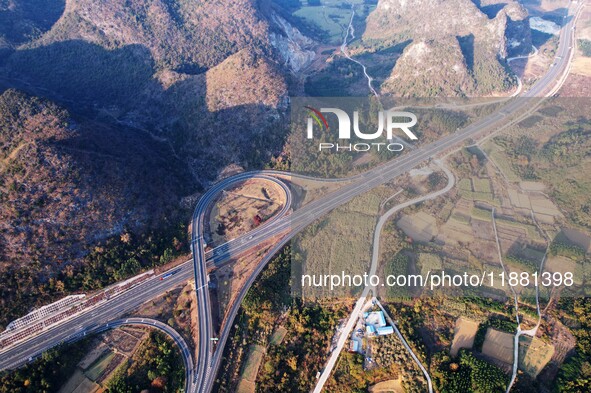 Vehicles drive on the Hongling interconnecting section of an expressway in Daliang town, Rongan County, Liuzhou city, South China's Guangxi...