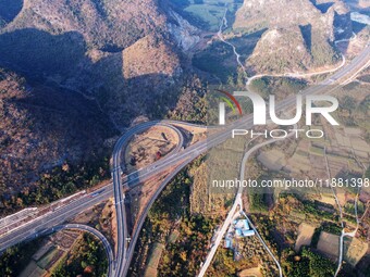 Vehicles drive on the Hongling interconnecting section of an expressway in Daliang town, Rongan County, Liuzhou city, South China's Guangxi...