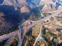 Vehicles drive on the Hongling interconnecting section of an expressway in Daliang town, Rongan County, Liuzhou city, South China's Guangxi...