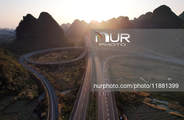 Vehicles drive on the Hongling interconnecting section of an expressway in Daliang town, Rongan County, Liuzhou city, South China's Guangxi...