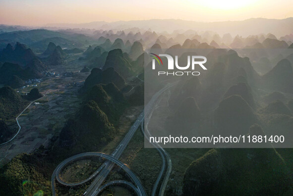 Vehicles drive on the Hongling interconnecting section of an expressway in Daliang town, Rongan County, Liuzhou city, South China's Guangxi...