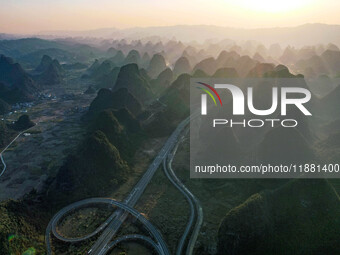 Vehicles drive on the Hongling interconnecting section of an expressway in Daliang town, Rongan County, Liuzhou city, South China's Guangxi...