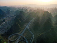 Vehicles drive on the Hongling interconnecting section of an expressway in Daliang town, Rongan County, Liuzhou city, South China's Guangxi...