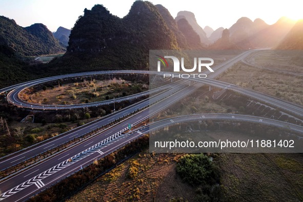 Vehicles drive on the Hongling interconnecting section of an expressway in Daliang town, Rongan County, Liuzhou city, South China's Guangxi...