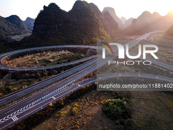 Vehicles drive on the Hongling interconnecting section of an expressway in Daliang town, Rongan County, Liuzhou city, South China's Guangxi...