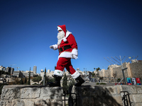 In Jerusalem, Israel, on December 19, 2024, Christian Palestinian Issa Kassissieh, dressed as Santa Claus, greets the public from the old ci...