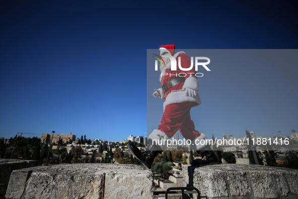 In Jerusalem, Israel, on December 19, 2024, Christian Palestinian Issa Kassissieh, dressed as Santa Claus, greets the public from the old ci...