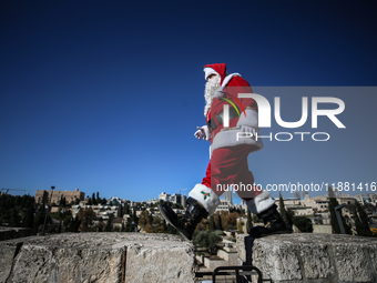 In Jerusalem, Israel, on December 19, 2024, Christian Palestinian Issa Kassissieh, dressed as Santa Claus, greets the public from the old ci...