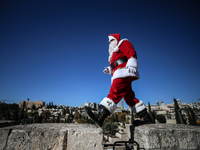 In Jerusalem, Israel, on December 19, 2024, Christian Palestinian Issa Kassissieh, dressed as Santa Claus, greets the public from the old ci...