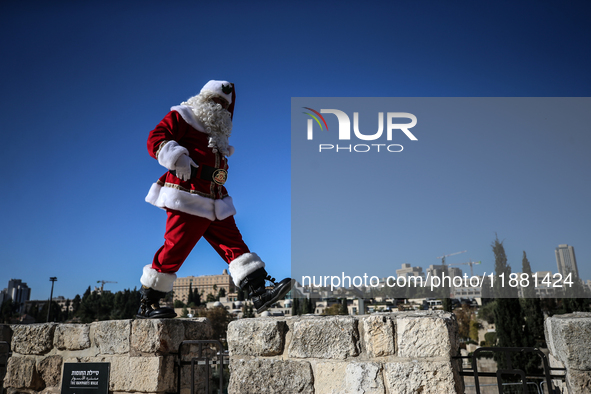 In Jerusalem, Israel, on December 19, 2024, Christian Palestinian Issa Kassissieh, dressed as Santa Claus, greets the public from the old ci...