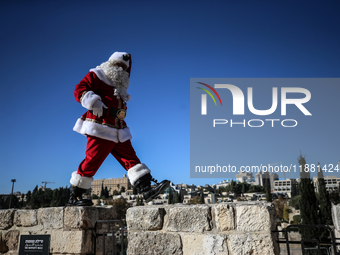 In Jerusalem, Israel, on December 19, 2024, Christian Palestinian Issa Kassissieh, dressed as Santa Claus, greets the public from the old ci...