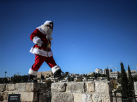 In Jerusalem, Israel, on December 19, 2024, Christian Palestinian Issa Kassissieh, dressed as Santa Claus, greets the public from the old ci...