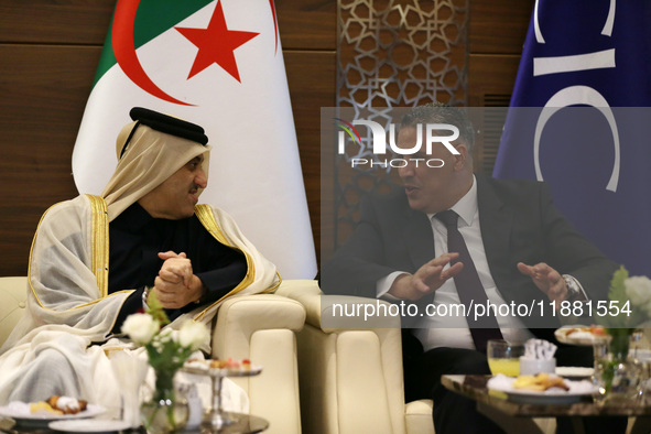 Algerian Minister of Housing Mohamed Tarek Belaribi (R) and Undersecretary General and Head of the Department of Economic Affairs at the Ara...