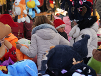 A colorful display of plush toys is at a market in Grafing, Bavaria, Germany, on December 15, 2024. Children browse the market atmosphere. (