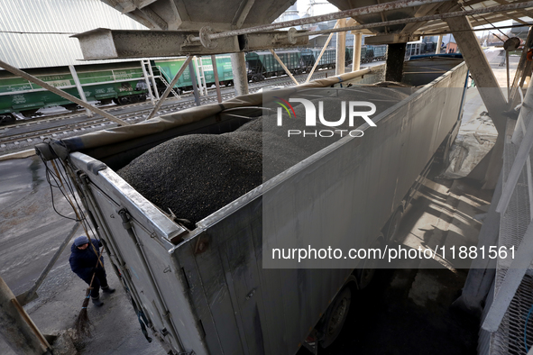 A truck is filled with sunflower seeds at a grain elevator in Chernihiv region, northern Ukraine, on December 18, 2024. 