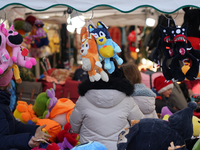 A colorful display of plush toys is at a market in Grafing, Bavaria, Germany, on December 15, 2024. Children browse the market atmosphere. (