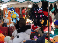 A colorful display of plush toys is at a market in Grafing, Bavaria, Germany, on December 15, 2024. Children browse the market atmosphere. (