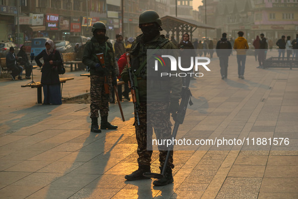 Indian security personnel stand guard along a road in Srinagar, Jammu and Kashmir, on December 19, 2024. Indian security forces kill five mi...