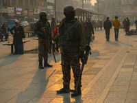 Indian security personnel stand guard along a road in Srinagar, Jammu and Kashmir, on December 19, 2024. Indian security forces kill five mi...