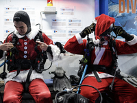 A diver dressed as Santa Claus prepares for a feeding performance to celebrate Christmas at Sea Life Bangkok Ocean World aquarium in Bangkok...