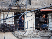 Palestinians inspect the site of an Israeli airstrike on a house amid the ongoing conflict between Israel and Hamas in Al-Maghazi, central G...