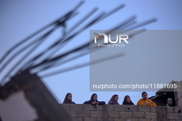 Palestinians inspect the site of an Israeli airstrike on a house amid the ongoing conflict between Israel and Hamas in Al-Maghazi, central G...