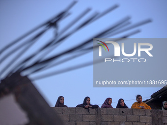 Palestinians inspect the site of an Israeli airstrike on a house amid the ongoing conflict between Israel and Hamas in Al-Maghazi, central G...