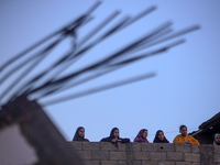 Palestinians inspect the site of an Israeli airstrike on a house amid the ongoing conflict between Israel and Hamas in Al-Maghazi, central G...