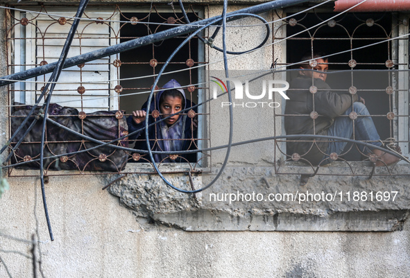 Palestinians inspect the site of an Israeli airstrike on a house amid the ongoing conflict between Israel and Hamas in Al-Maghazi, central G...