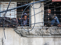 Palestinians inspect the site of an Israeli airstrike on a house amid the ongoing conflict between Israel and Hamas in Al-Maghazi, central G...