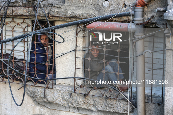 Palestinians inspect the site of an Israeli airstrike on a house amid the ongoing conflict between Israel and Hamas in Al-Maghazi, central G...