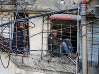 Palestinians inspect the site of an Israeli airstrike on a house amid the ongoing conflict between Israel and Hamas in Al-Maghazi, central G...