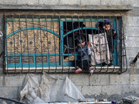 Palestinians inspect the site of an Israeli airstrike on a house amid the ongoing conflict between Israel and Hamas in Al-Maghazi, central G...