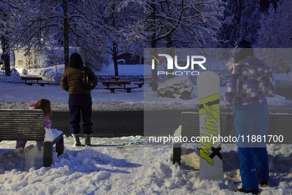 An evening scene occurs at a bus stop in Grainau, Garmisch-Partenkirchen, Bavaria, Germany, on December 13, 2024 