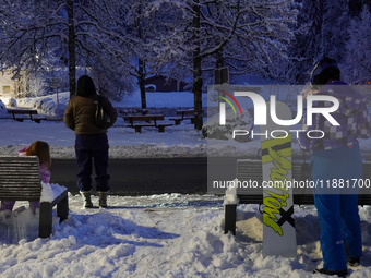 An evening scene occurs at a bus stop in Grainau, Garmisch-Partenkirchen, Bavaria, Germany, on December 13, 2024 (