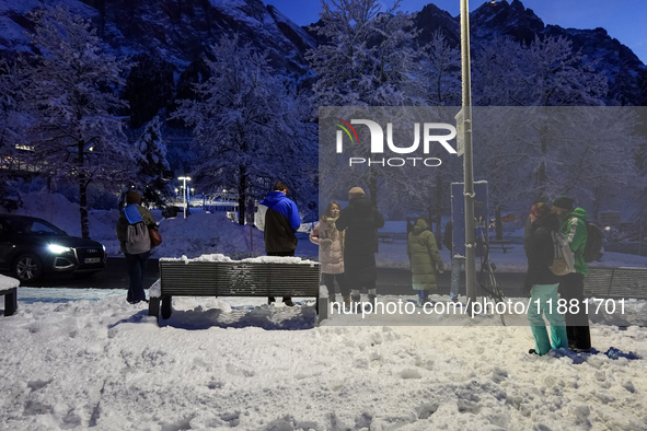 An evening scene occurs at a bus stop in Grainau, Garmisch-Partenkirchen, Bavaria, Germany, on December 13, 2024 