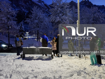 An evening scene occurs at a bus stop in Grainau, Garmisch-Partenkirchen, Bavaria, Germany, on December 13, 2024 (