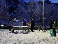 An evening scene occurs at a bus stop in Grainau, Garmisch-Partenkirchen, Bavaria, Germany, on December 13, 2024 (