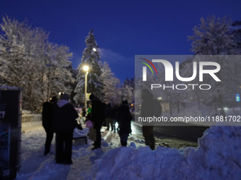 An evening scene occurs at a bus stop in Grainau, Garmisch-Partenkirchen, Bavaria, Germany, on December 13, 2024 (