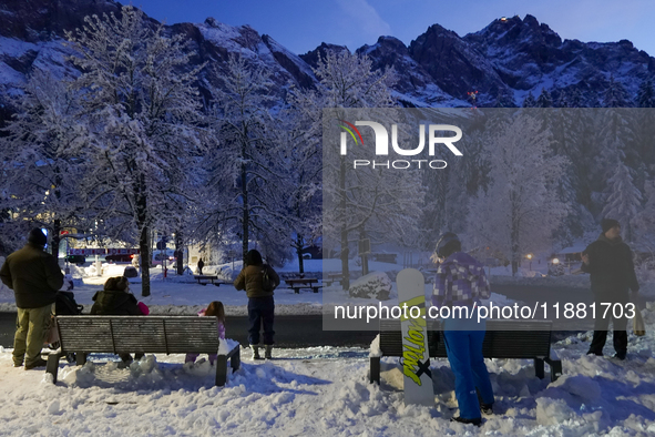 An evening scene occurs at a bus stop in Grainau, Garmisch-Partenkirchen, Bavaria, Germany, on December 13, 2024 