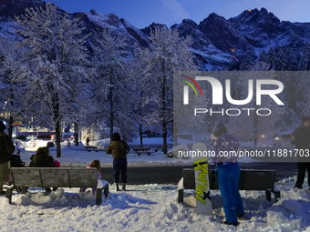 An evening scene occurs at a bus stop in Grainau, Garmisch-Partenkirchen, Bavaria, Germany, on December 13, 2024 (