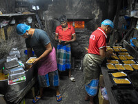 Workers make traditional fruit cake in a wood fire oven at a 100-year-old bakery ahead of Christmas celebrations in Kolkata, India, on Decem...