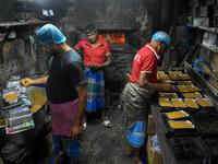 Workers make traditional fruit cake in a wood fire oven at a 100-year-old bakery ahead of Christmas celebrations in Kolkata, India, on Decem...