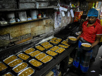 Workers make traditional fruit cake in a wood fire oven at a 100-year-old bakery ahead of Christmas celebrations in Kolkata, India, on Decem...