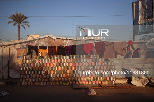 A displaced Palestinian stands in front of his tent in Deir al-Balah, on December 19, 2024, as the war between Israel and Hamas militants co...